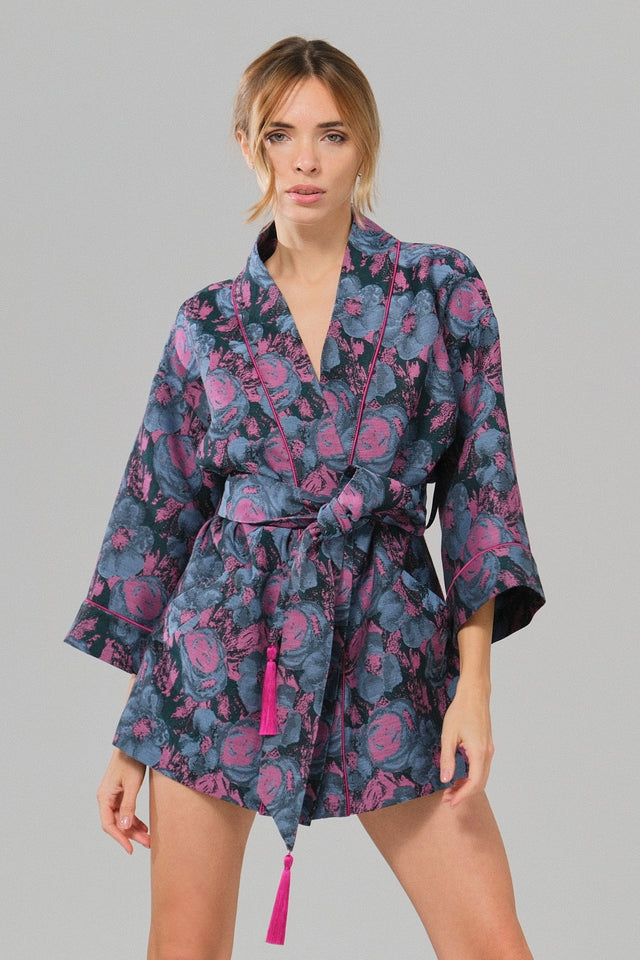 Woman wearing a floral patterned kimano on a gray background